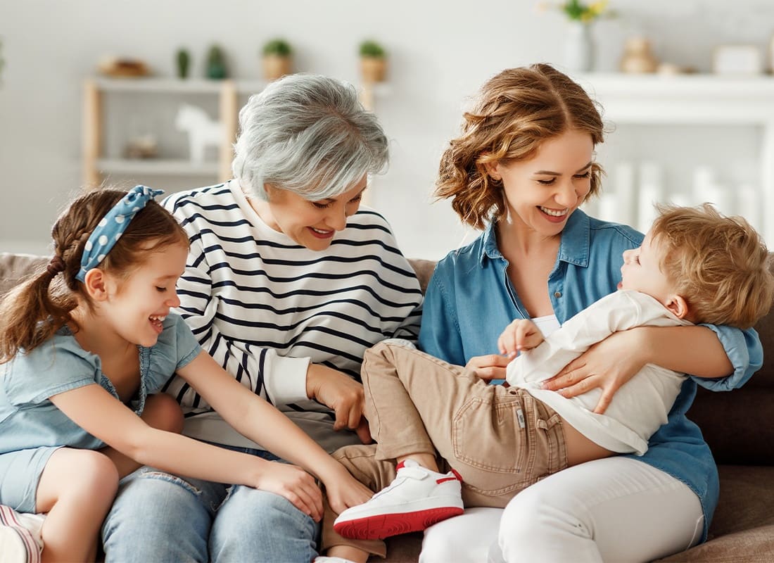 Personal Insurance - Multi Generational Relatives Having Fun on Sofa